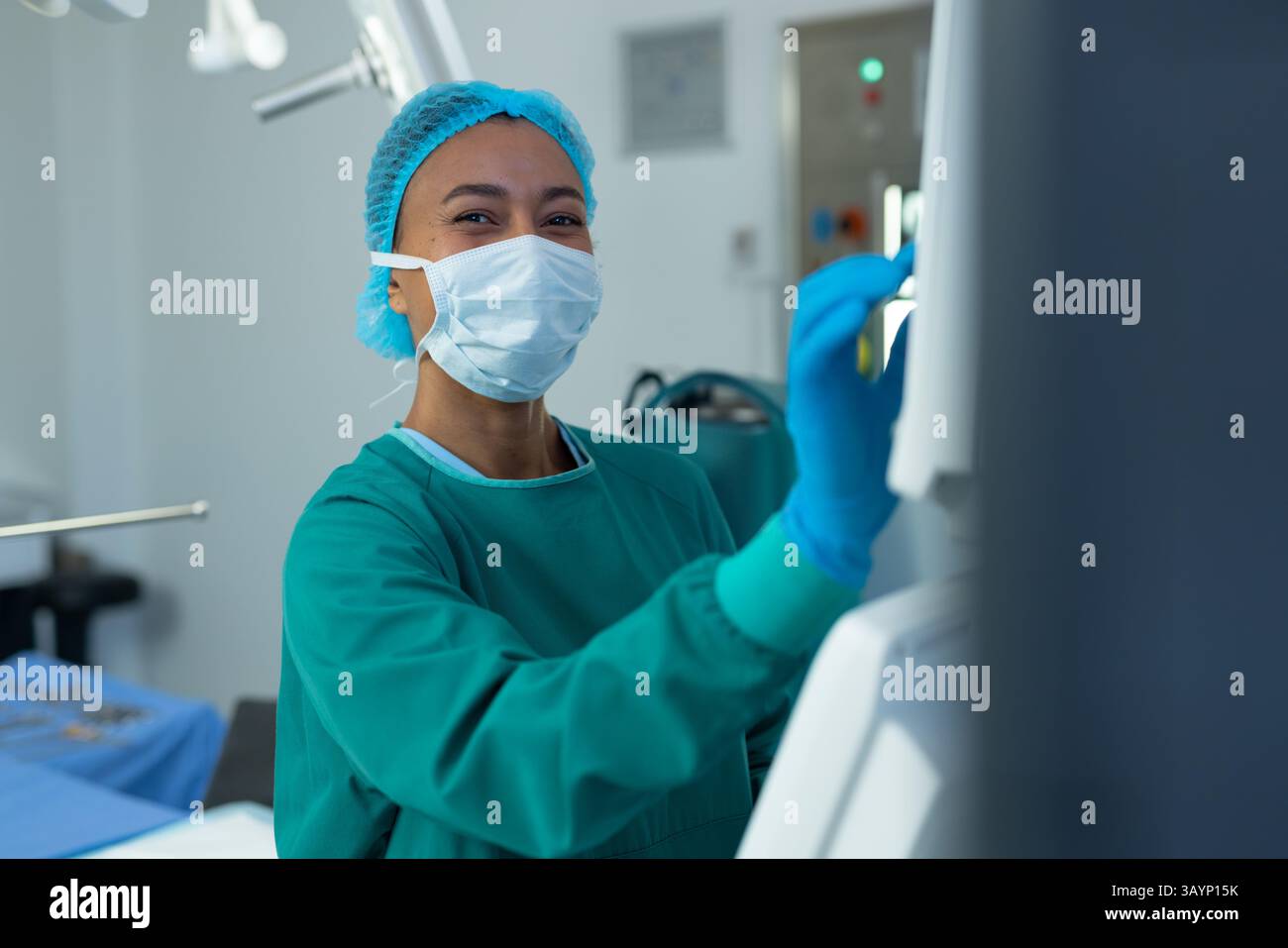 Surgeon Using Monitor African American woman surgeon touching touchscreen monitor in ...