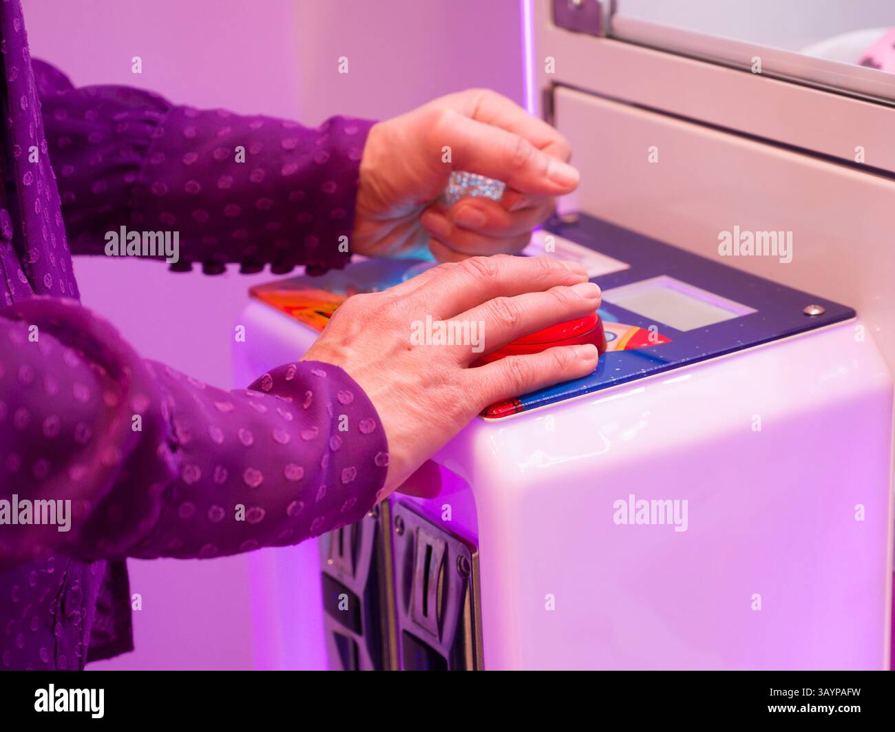 A woman playing arcade Stock Photo