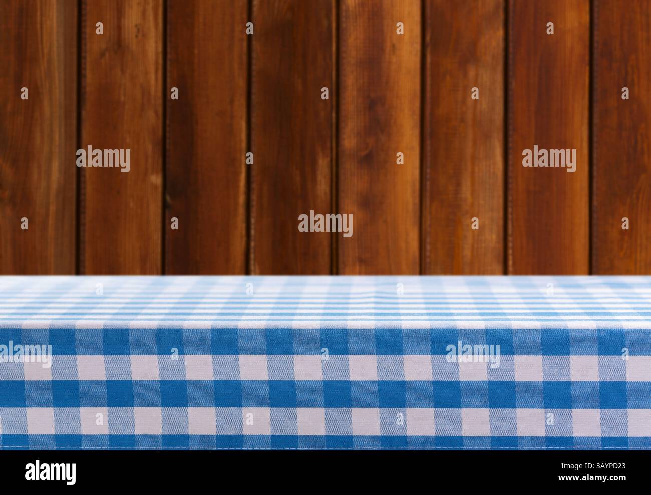 Empty blue and white checkered tablecloth on old wooden background Stock Photo