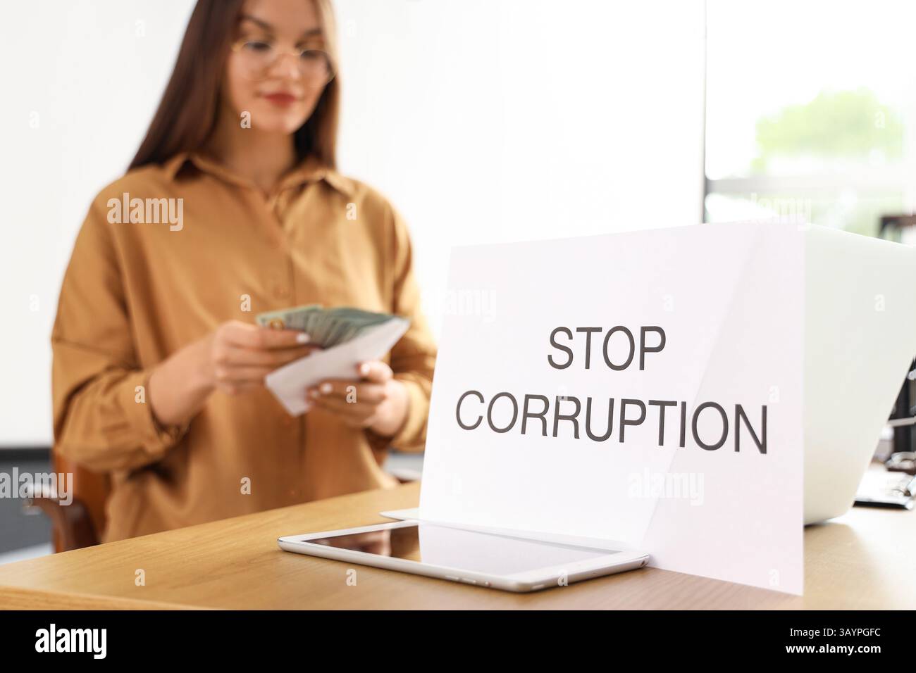 Paper with text STOP CORRUPTION on teacher's table in classroom ...