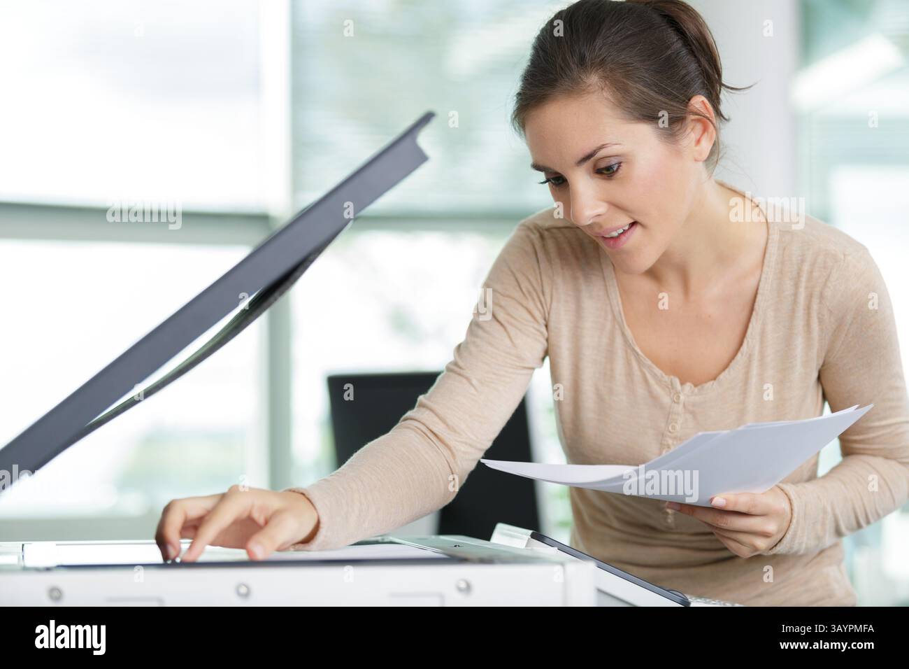 a lady using a photocopier Stock Photo