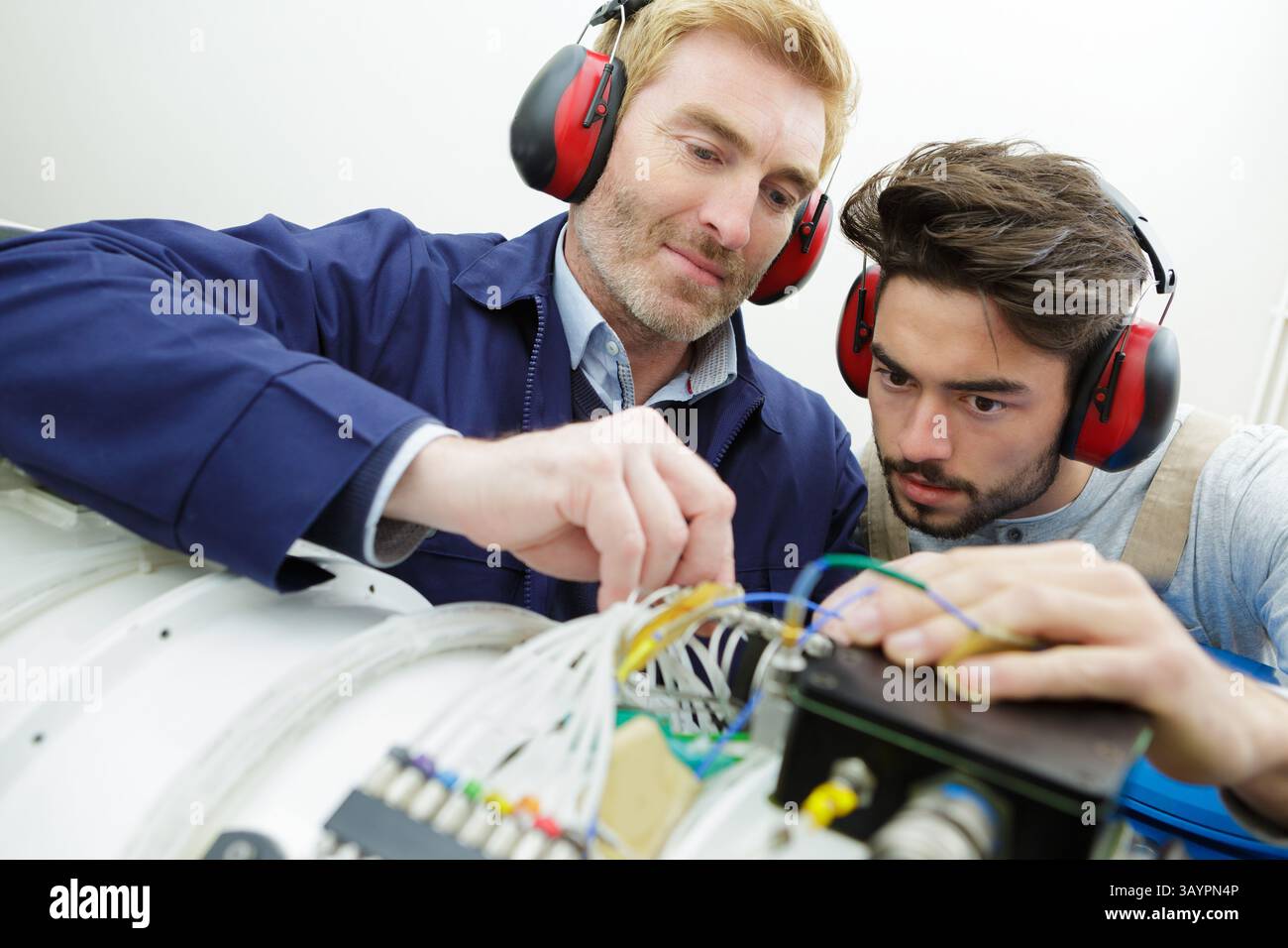 technicians maintaining record of rack mounted server Stock Photo
