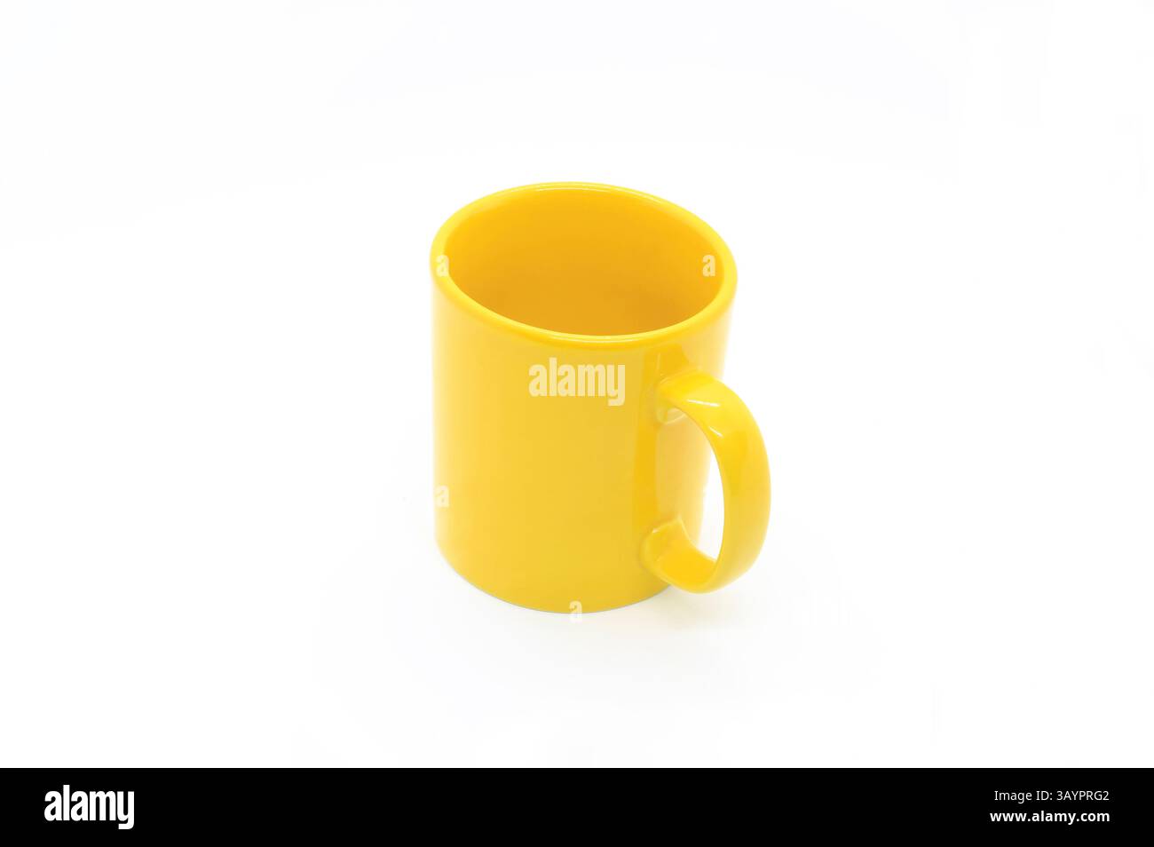 Bright yellow ceramic cup with handle isolated on white background Stock Photo