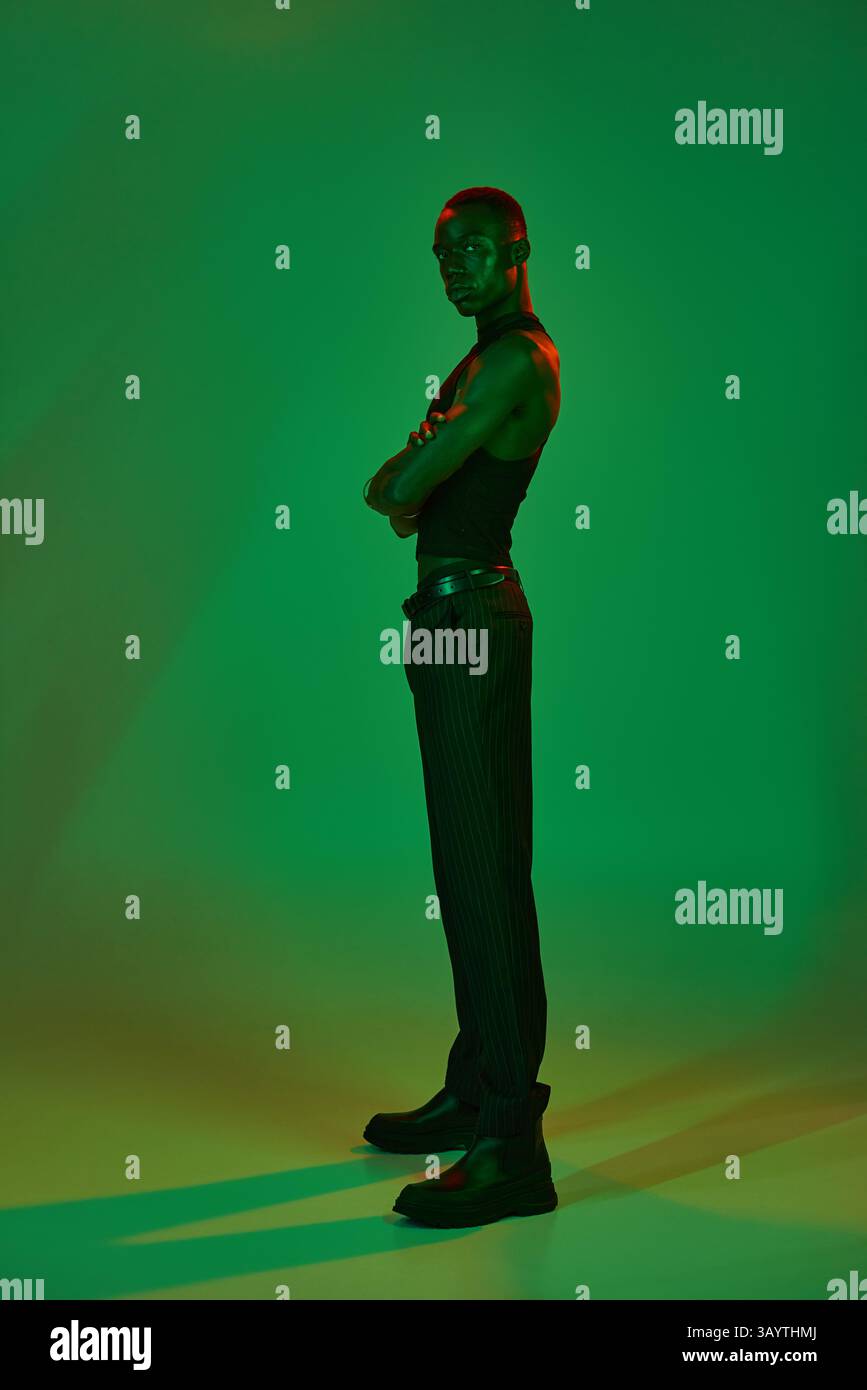 Stylish young man poses confidently, highlighting his vibrant attire ...