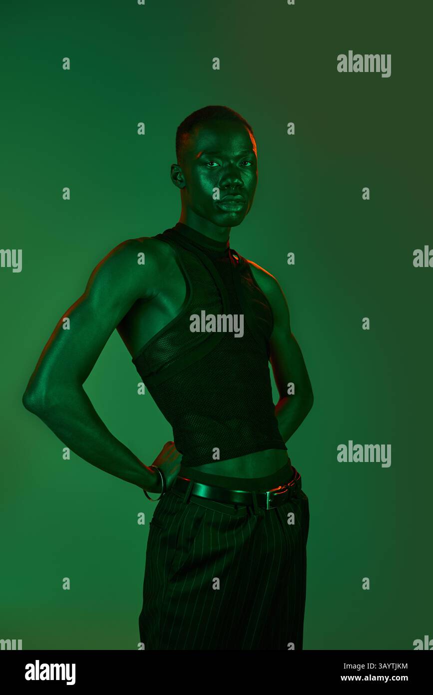 A stylish young African American man poses confidently in trendy attire ...