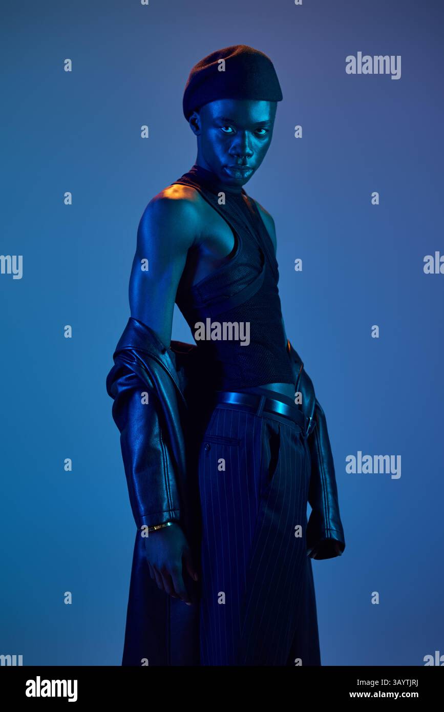 A young african american man confidently shows off his stylish outfit ...