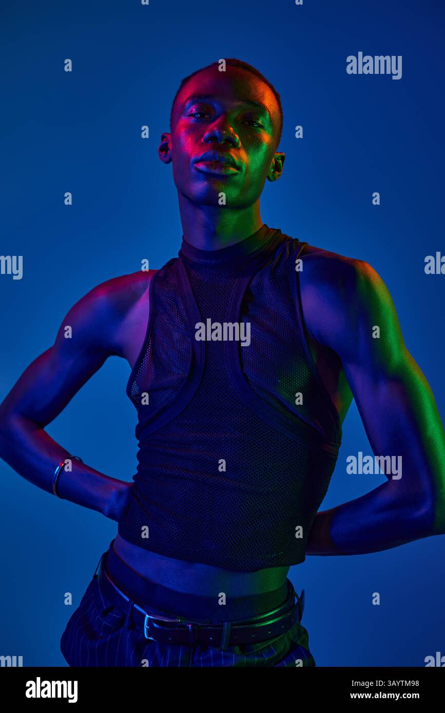 A young african american man poses confidently in vibrant attire that ...