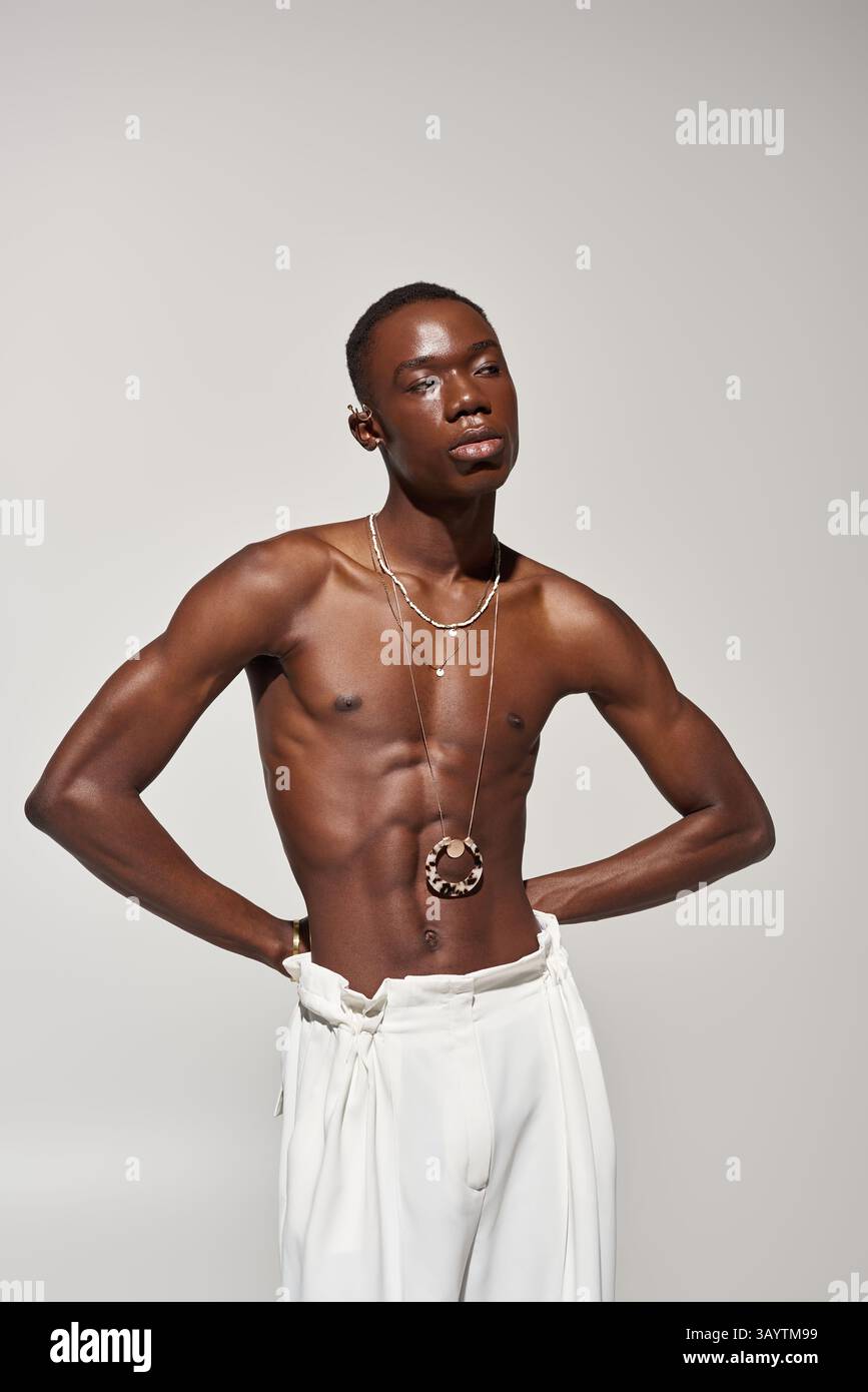 A young african american man poses confidently in stylish attire that ...