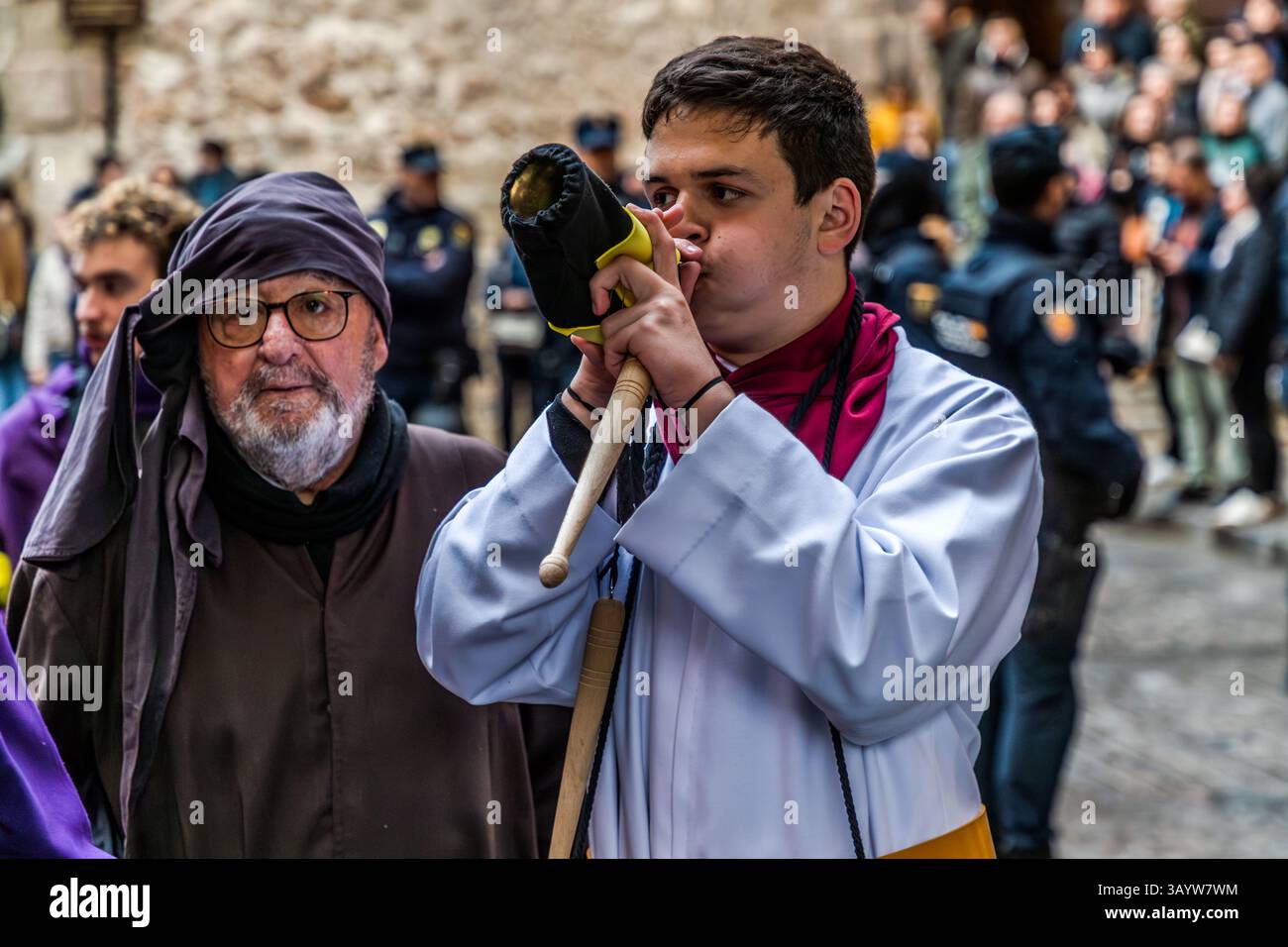 Turbas de Cuenca in purple robes make a deafening noise with their drums (tambores) and trumpets (clarines) at the head of the Camino del Calvario procession, which passes through Cuenca on Good Friday. Calle del Fuero, Cuenca, Castilla-La Mancha, Spain Stock Photo