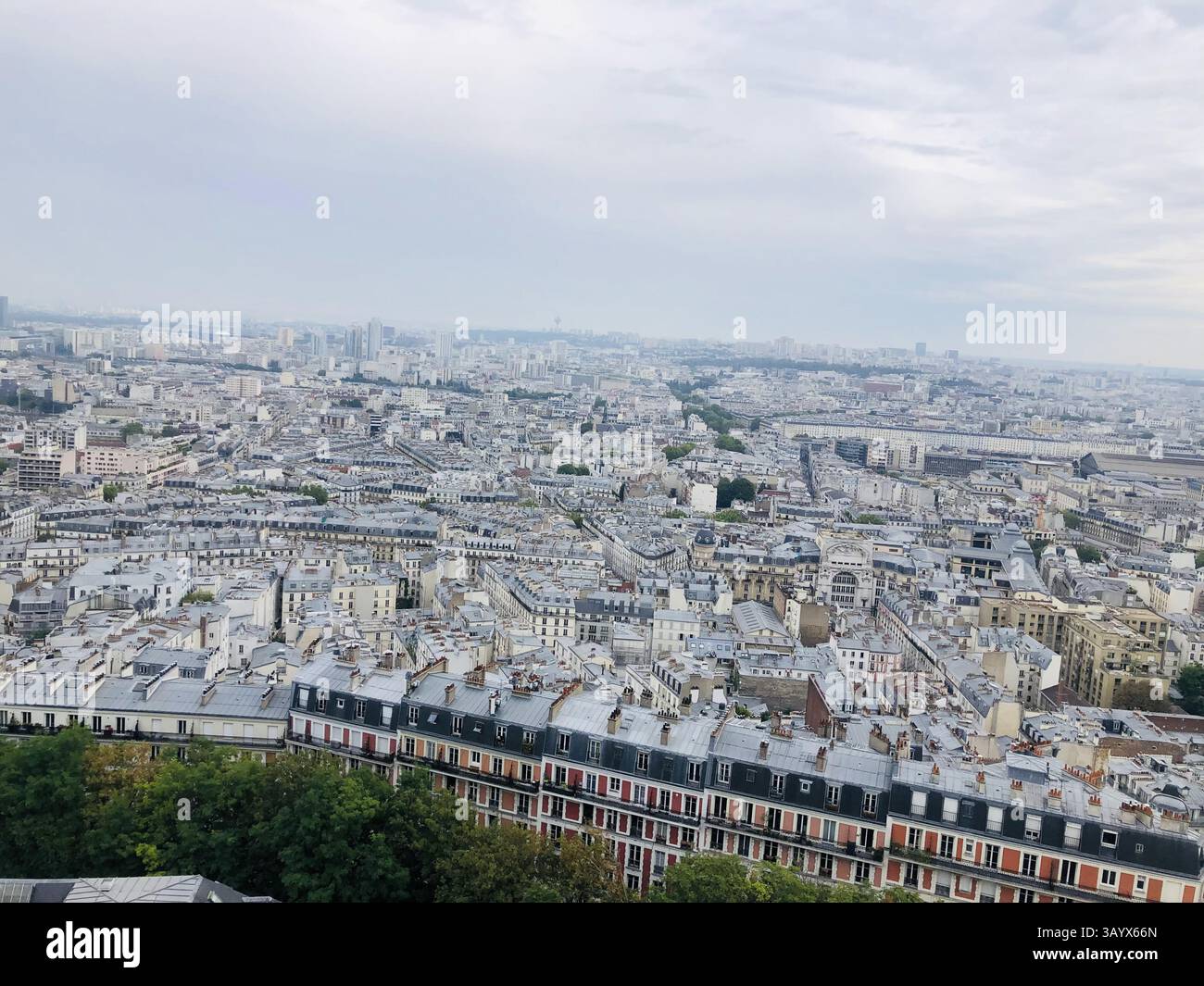 Wider Panoramic View of Paris Rooftops and Urban Spread on Cloudy Day - Smartphone Captured Stock Image