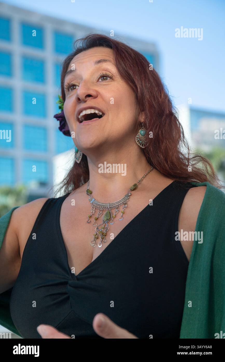Opera singer performing outdoors in urban setting Stock Photo - Alamy