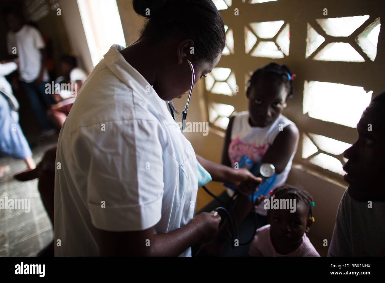 Feb 26, 2010 - Saint-Marc, Artibonite, Haiti - A doctor checks the blood pressure of a new patient at a YWAM medical clinic. Make-shift clincs sprang up all around Haiti to cope with the large number of casualties. (Credit Image: © George Hsia/ZUMApress.com) Stock Photo