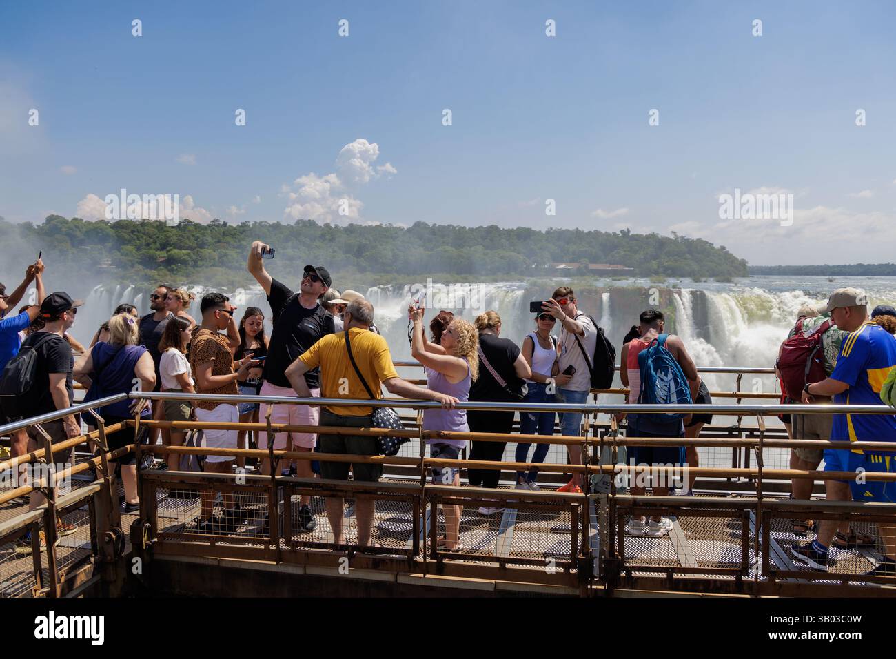 Puerto Iguazu, Misiones, Argentina - April 5th, 2025: Tourists watching the Devil's Throat waterfall at Iguazu Falls. Stock Photo