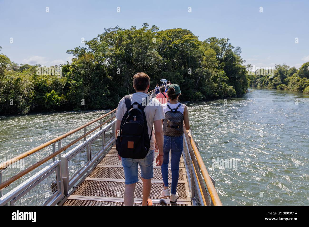 Puerto Iguazu, Misiones, Argentina - April 5th, 2025: Tourists trucking along the Iguazu Falls walkways. Stock Photo