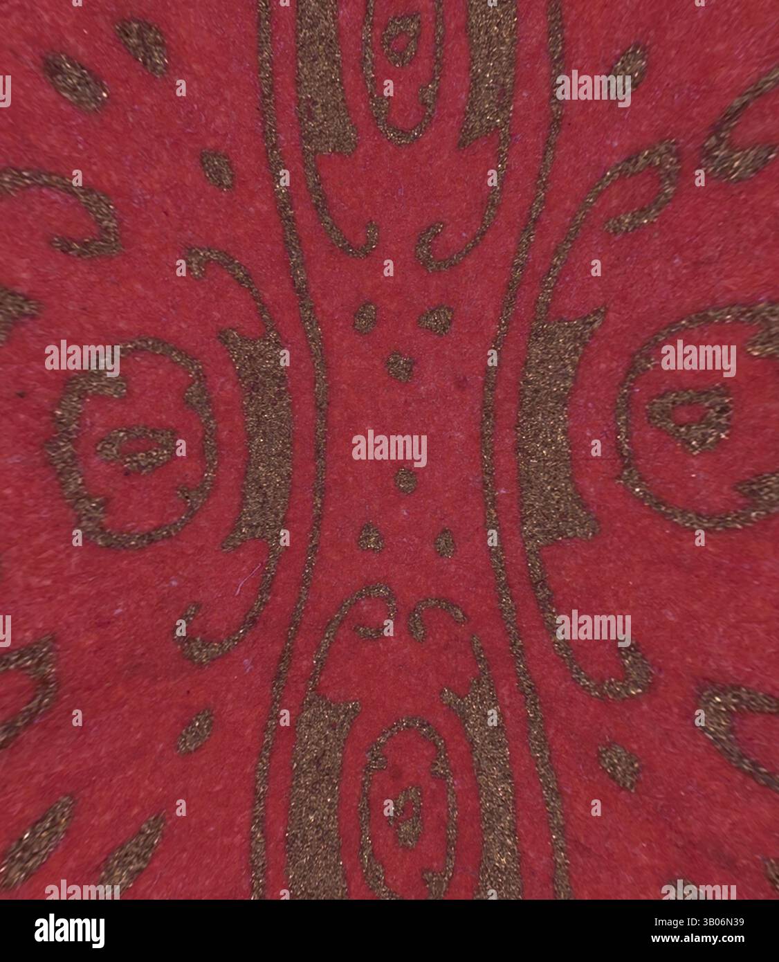 A vibrant red surface adorned with intricate gold patterns, featuring ...