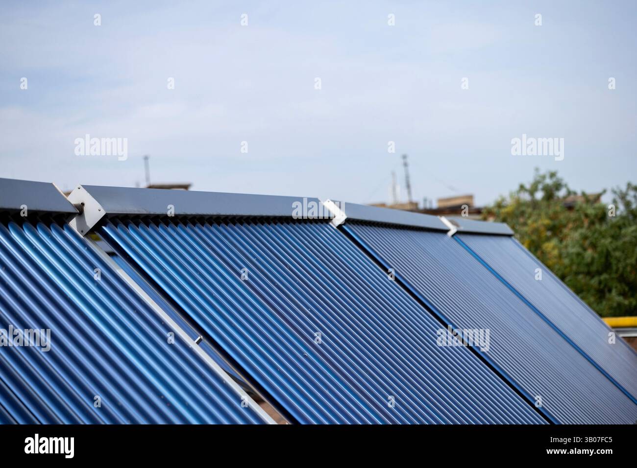 А solar water heating collectors, equipped with blue vacuum tubes, are ...