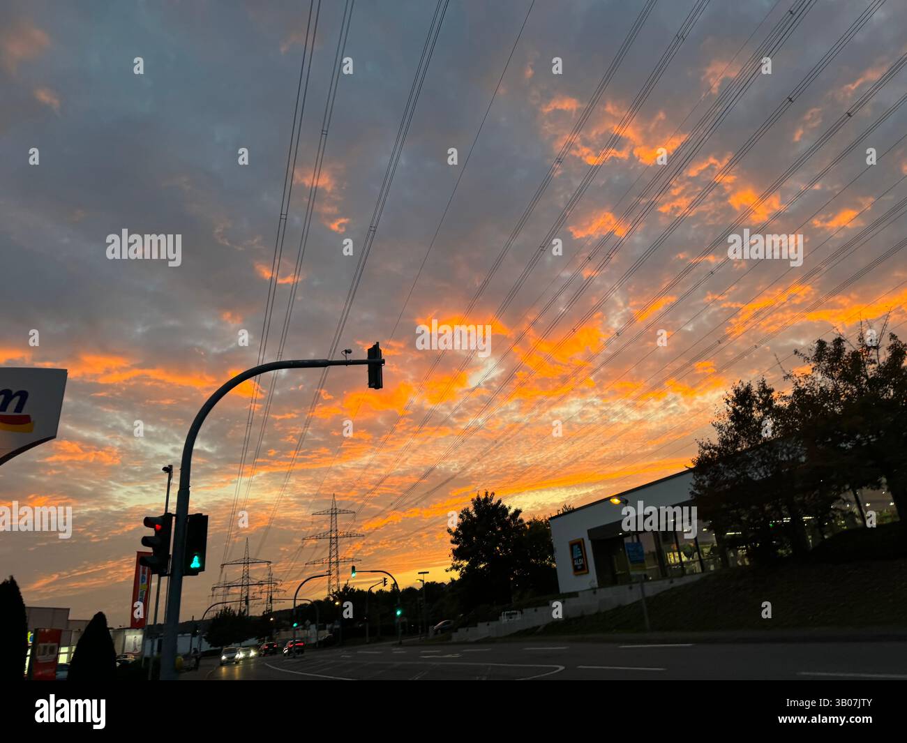 Sunset Over Street with Traffic Lights and Power Lines, Velbert, Germany - Smartphone Captured Stock Image