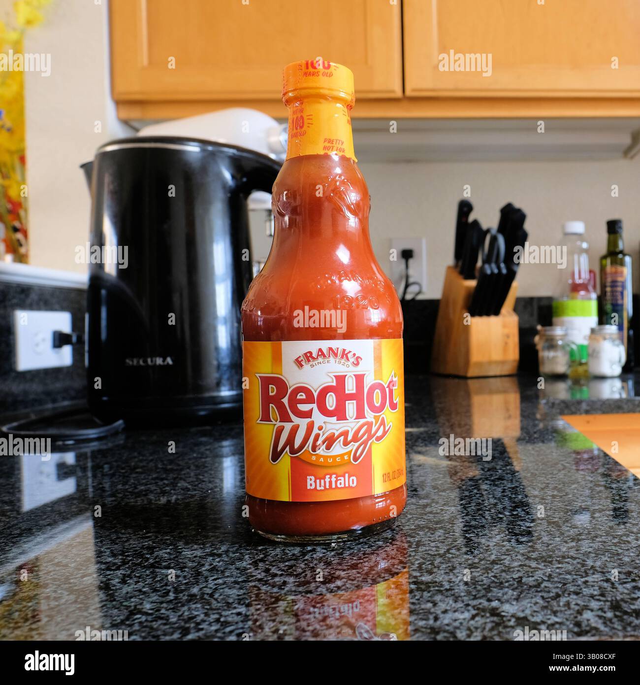 A glass bottle of Frank's RedHot Buffalo Wings Sauce on a kitchen ...