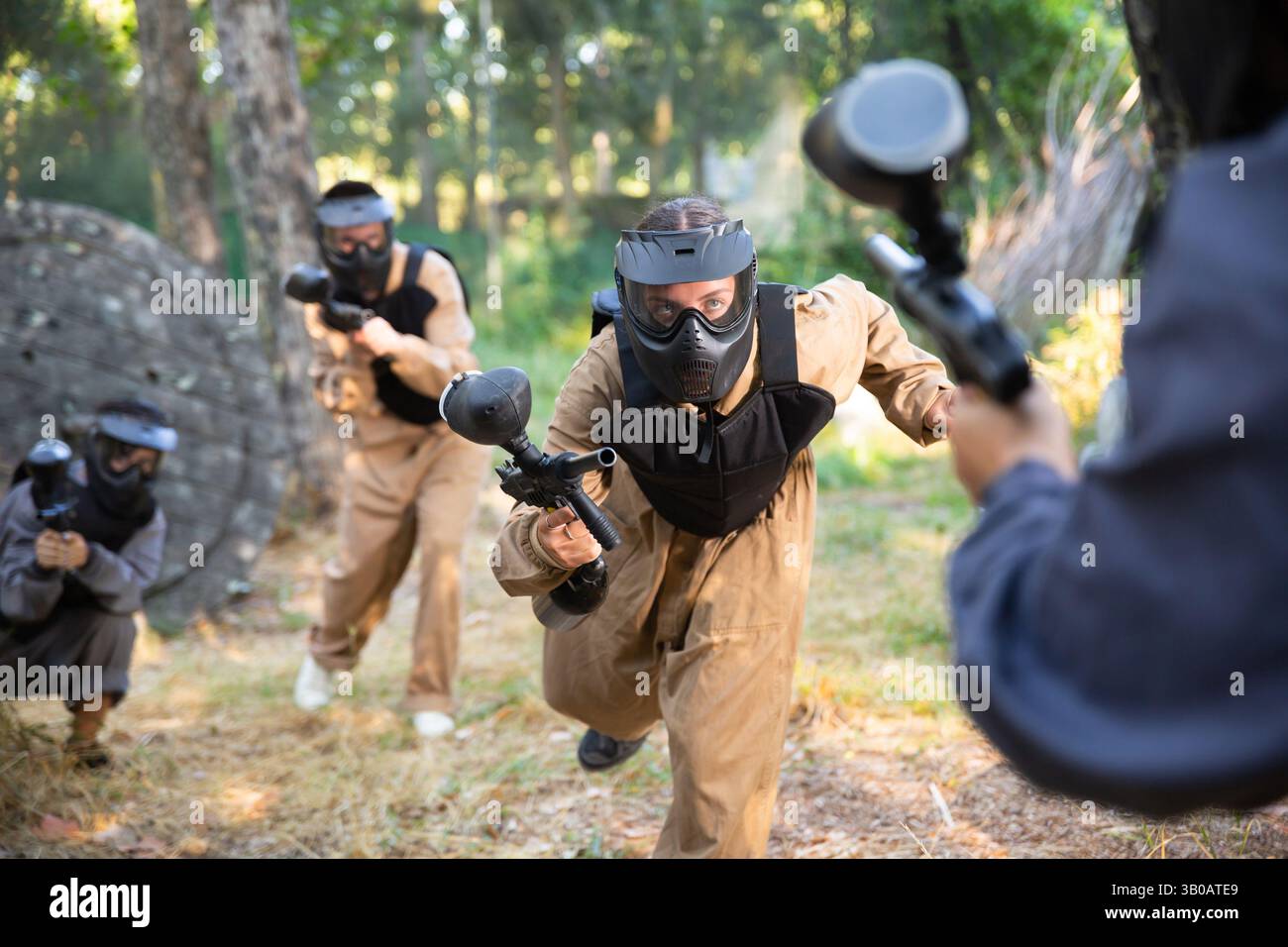 Team of paintball players attacks enemy at an army training ground Stock Photo