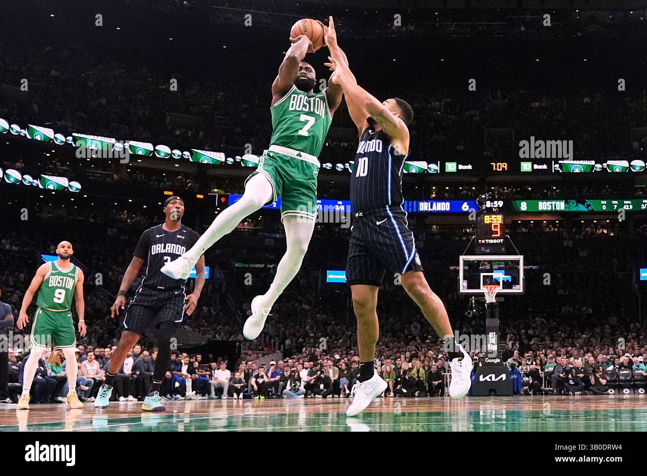 Boston Celtics guard Jaylen Brown (7) takes a shot while pressured by
