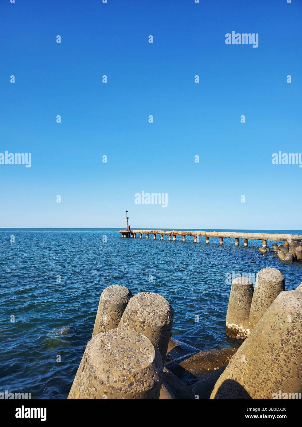 Concrete Tetrapod Breakwaters and Jetty Leading into Calm Blue Ocean ...
