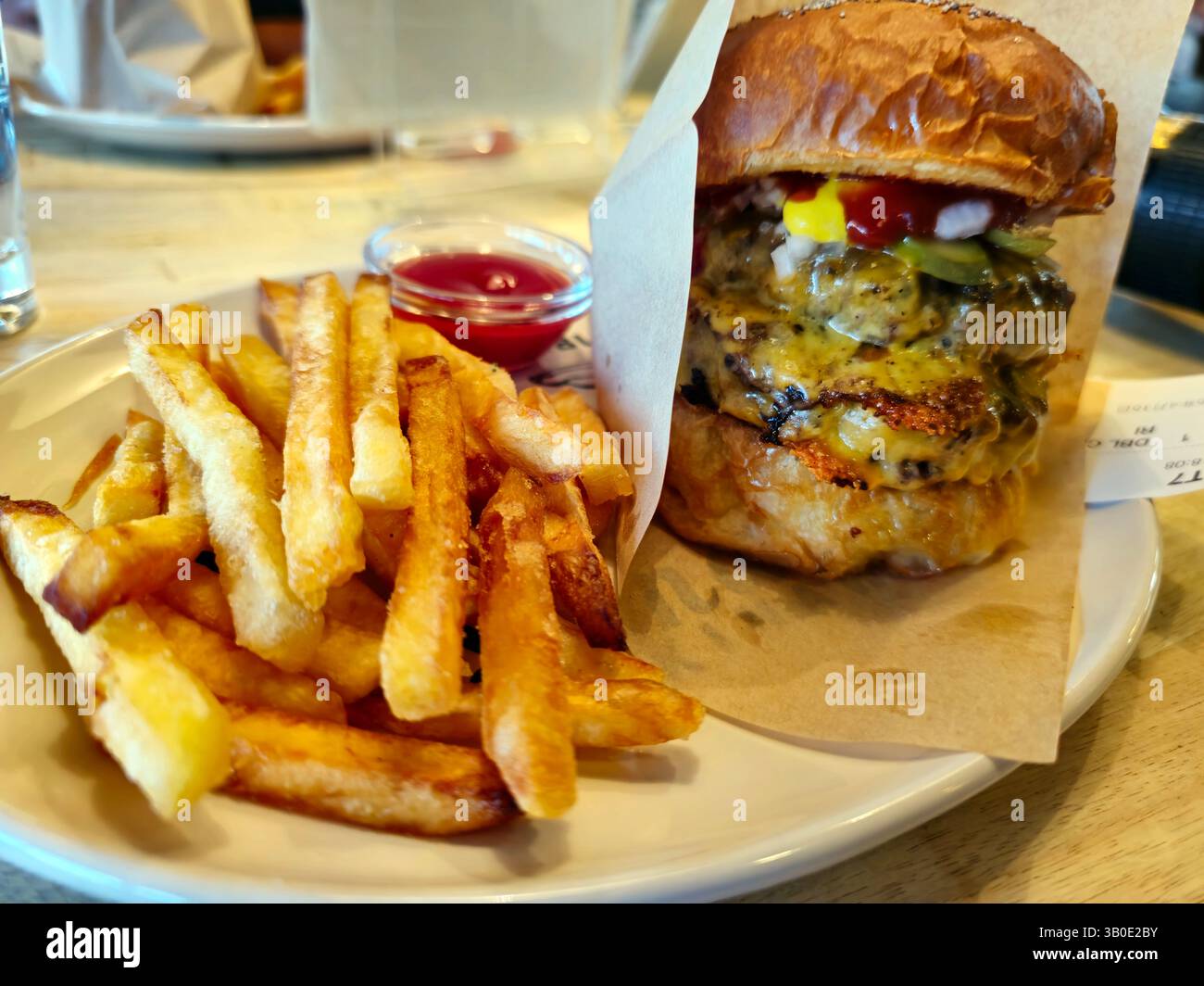 A juicy double cheeseburger with fries at Sandbox Burgers in Chatan, Okinawa, Japan. - Smartphone Captured Stock Image