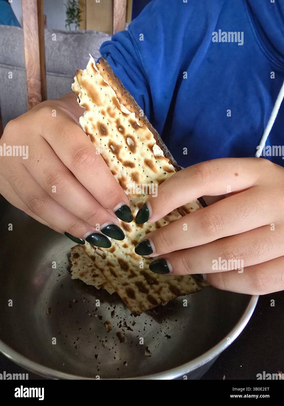 A young woman preparing Matzah brei during the Passover holiday. - Smartphone Captured Stock Image
