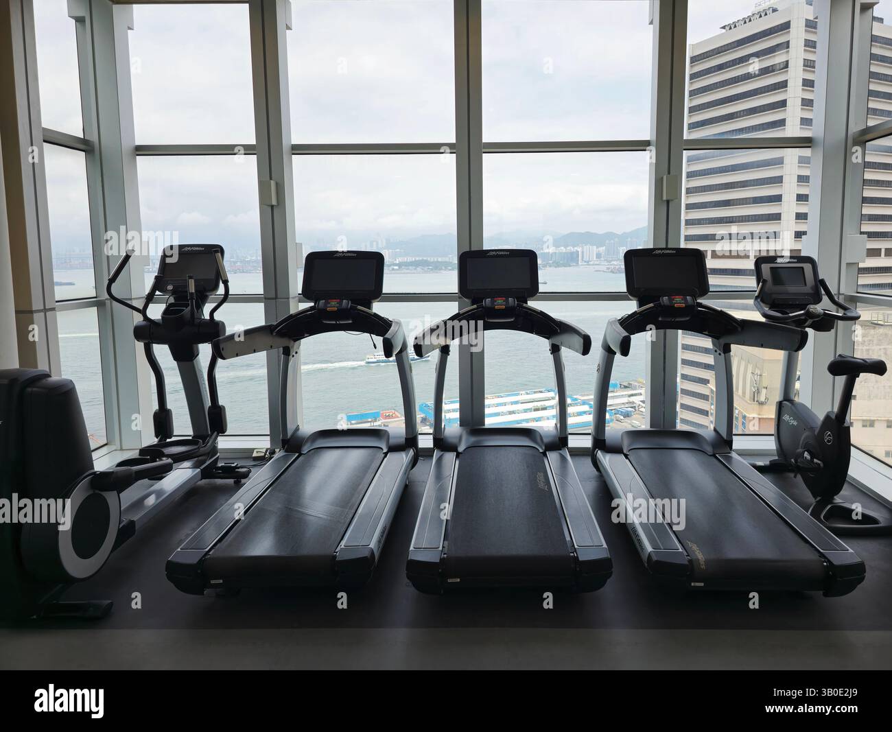 The Fitness center overlooking Victoria Harbour at the JEN hotel by Shangri-La in Sai Wan, Hong Kong. - Smartphone Captured Stock Image