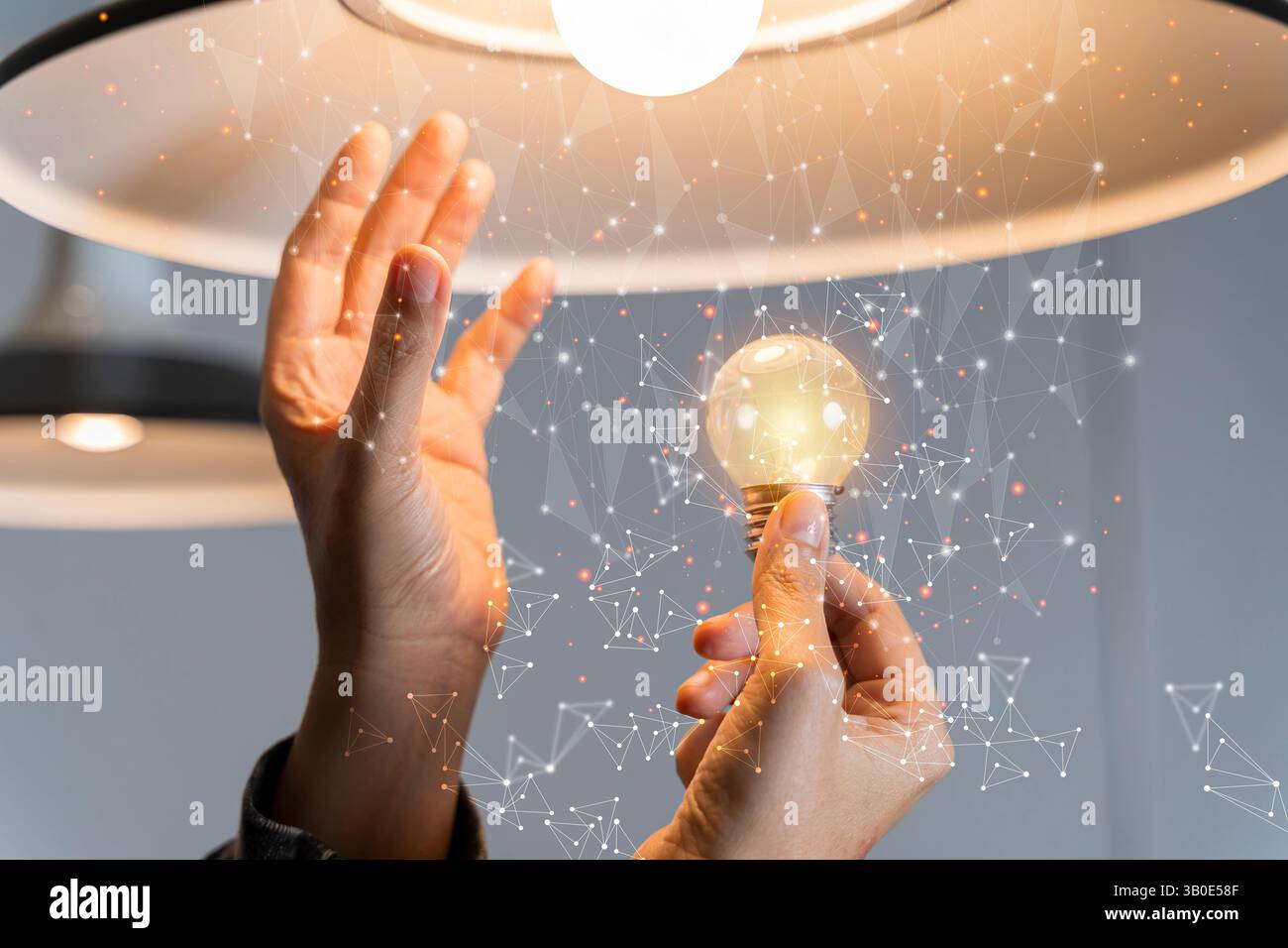 Hand of businessman holding illuminated light bulb with network connection line, idea, innovation and inspiration concept. Creativity with bulbs that Stock Photo