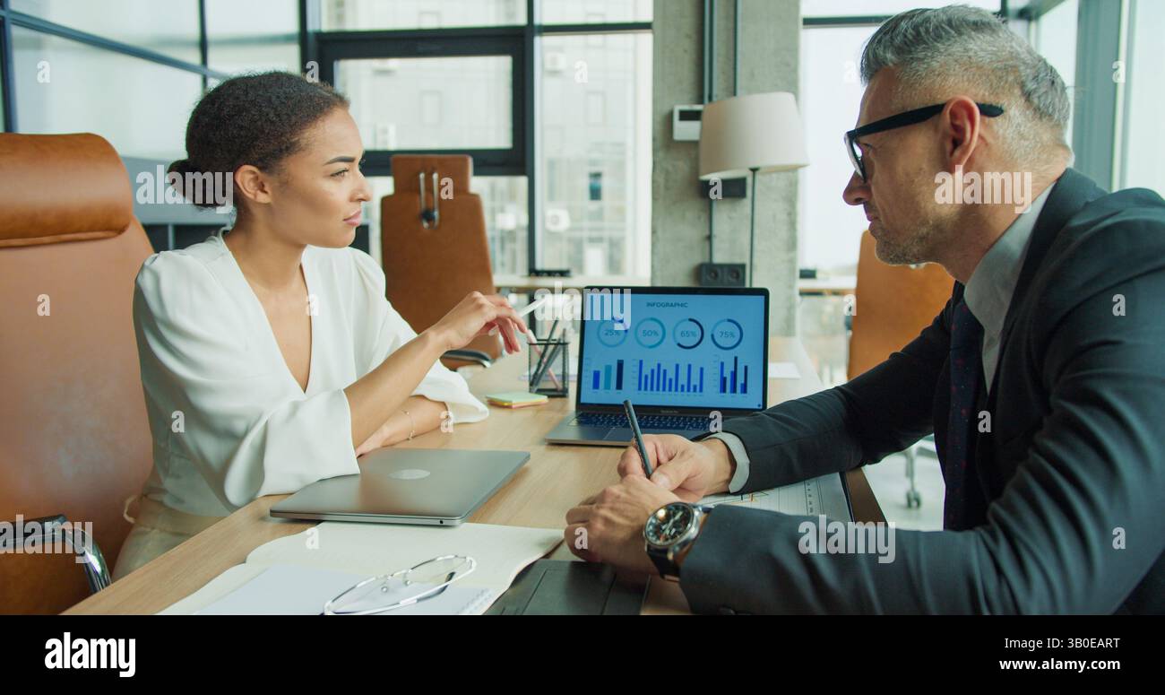 Business partners analyzing infographic data report Stock Photo