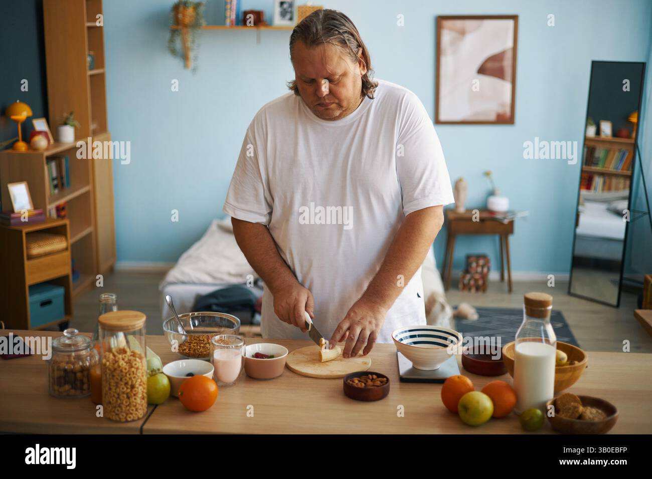 Preparing Breakfast in Cozy, Well-Lit Kitchen Stock Photo