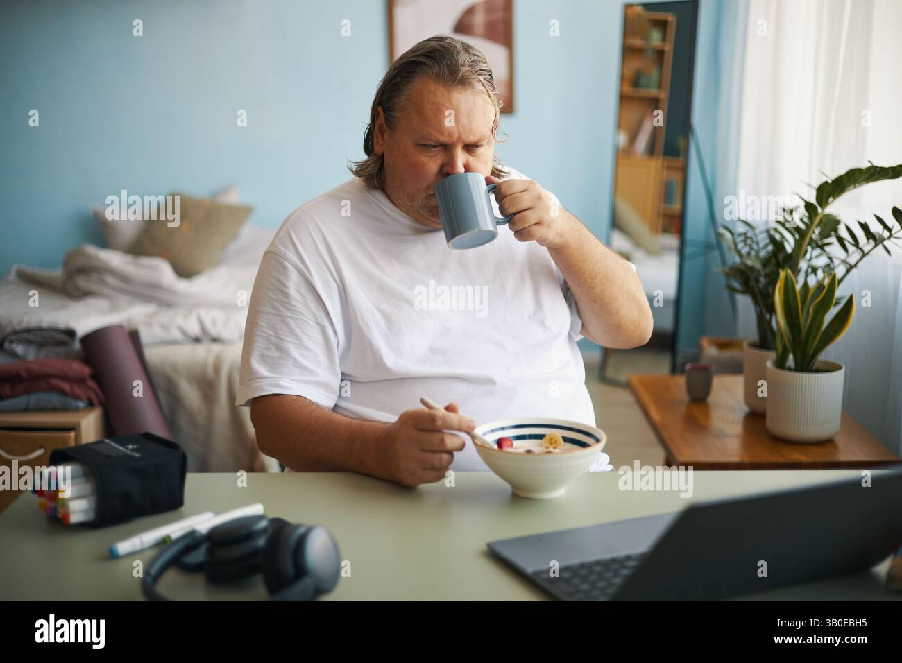 Enjoying Breakfast While Working From Home Stock Photo