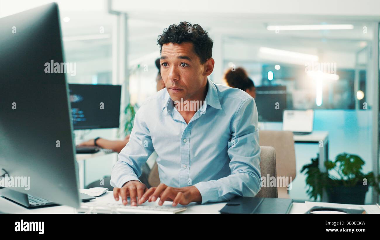 Coding, man and typing on computer in office for app development, software maintenance and testing website. Professional, employee and technology for Stock Photo