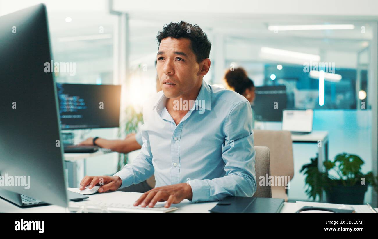 Programmer, man and reading computer in office for software development, typing code or app testing. Programming, employee and technology for database Stock Photo