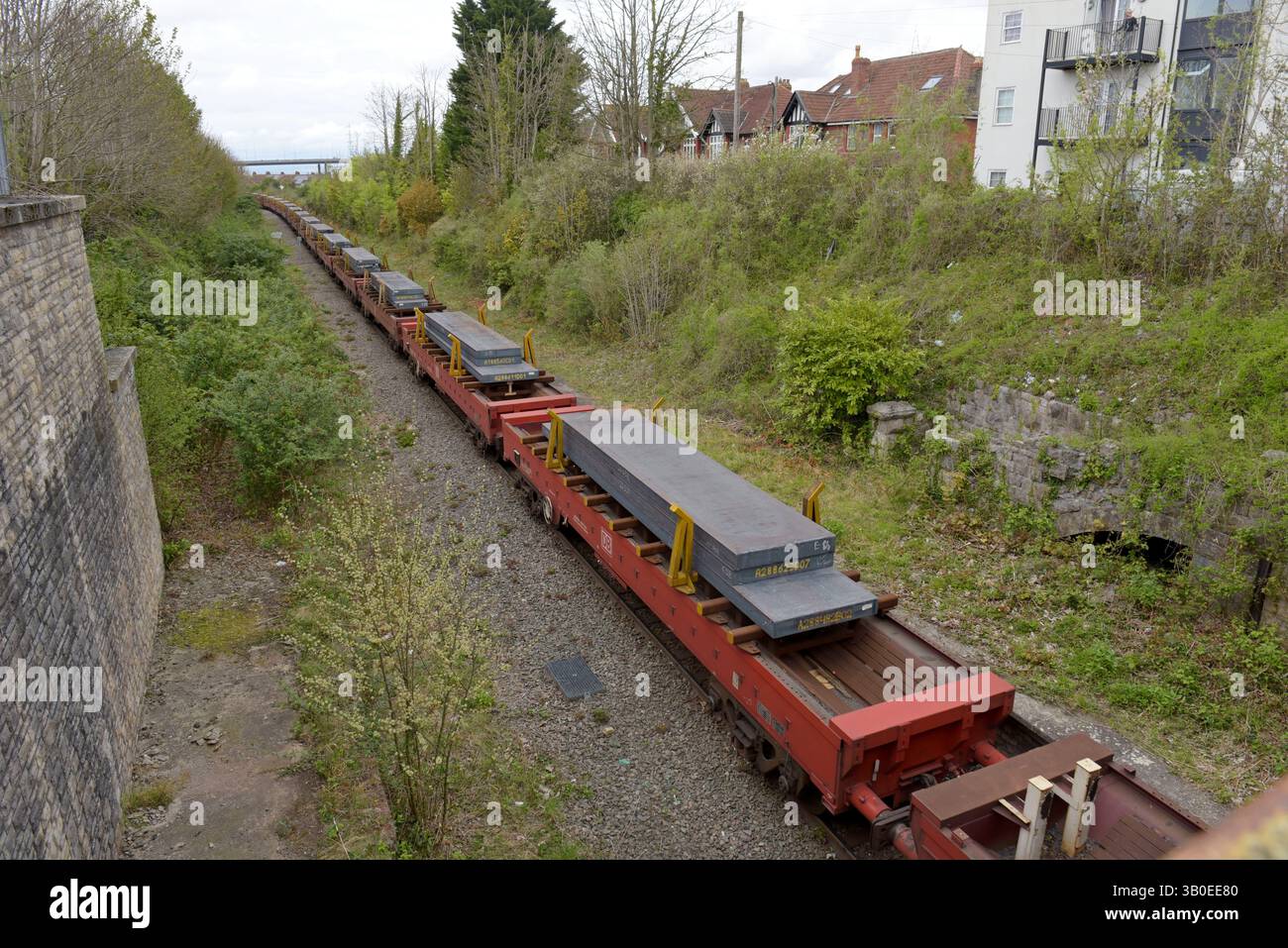 Imported slabs of steel leaving Royal Portbury Docks by train seen at the site of Pill Station, near Bristol, April 2025 Stock Photo