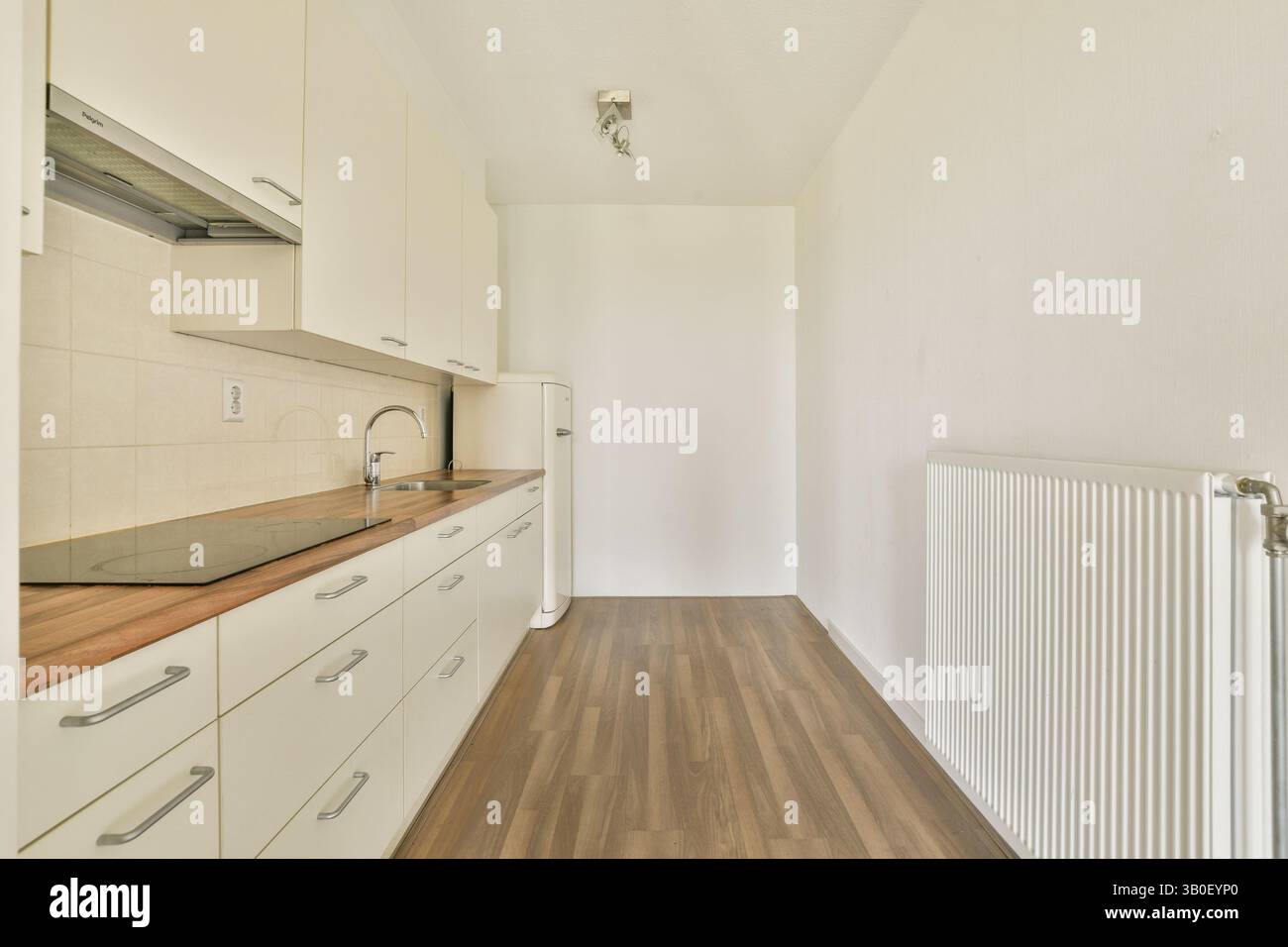 A minimalist kitchen featuring sleek cabinetry, a subtle color palette ...