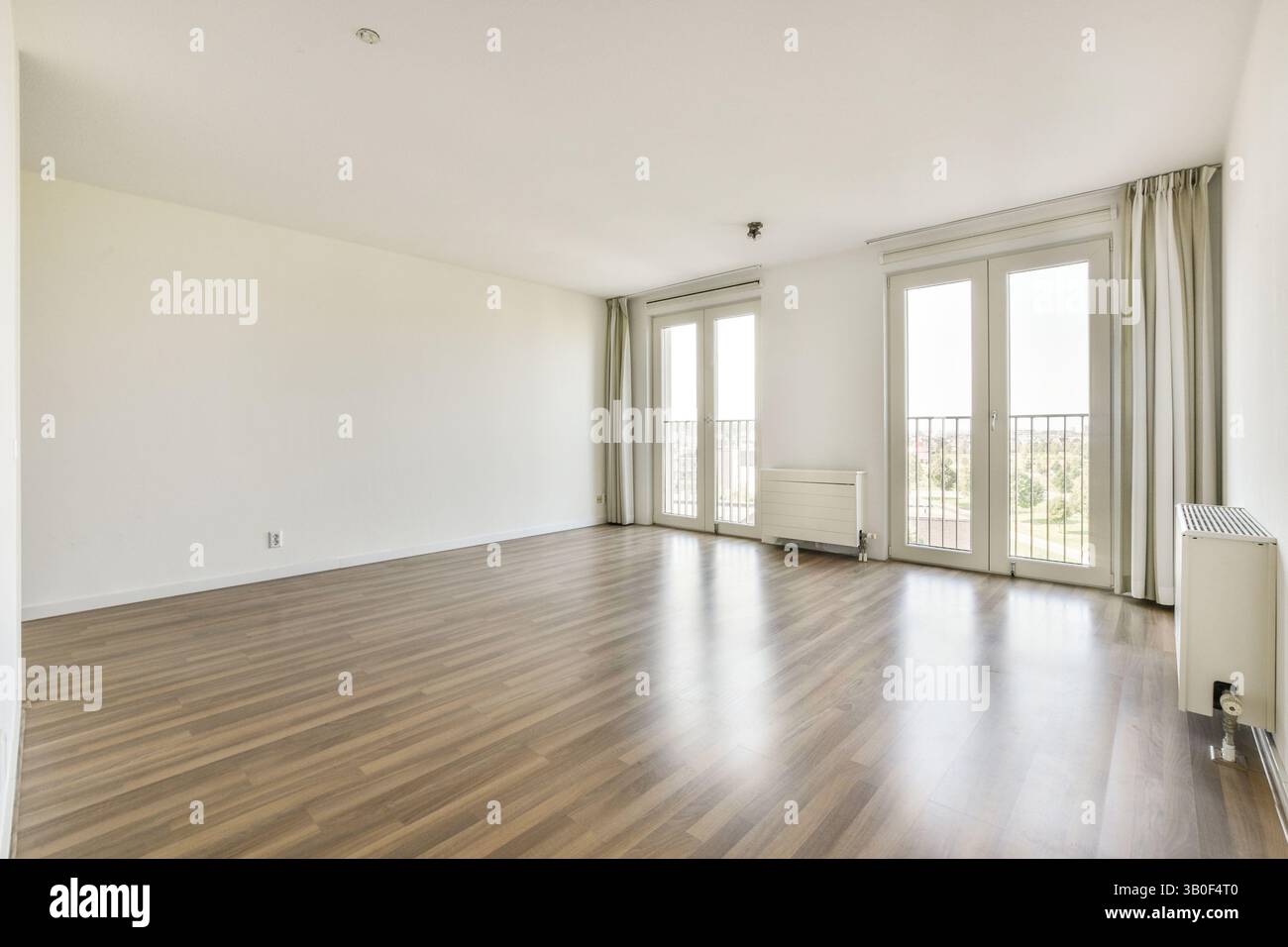 Bright and spacious apartment interior featuring wooden flooring, large ...