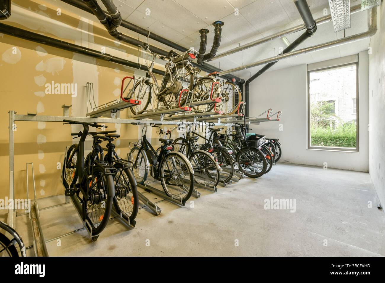 A well-organized storage room featuring multiple bicycle racks ...