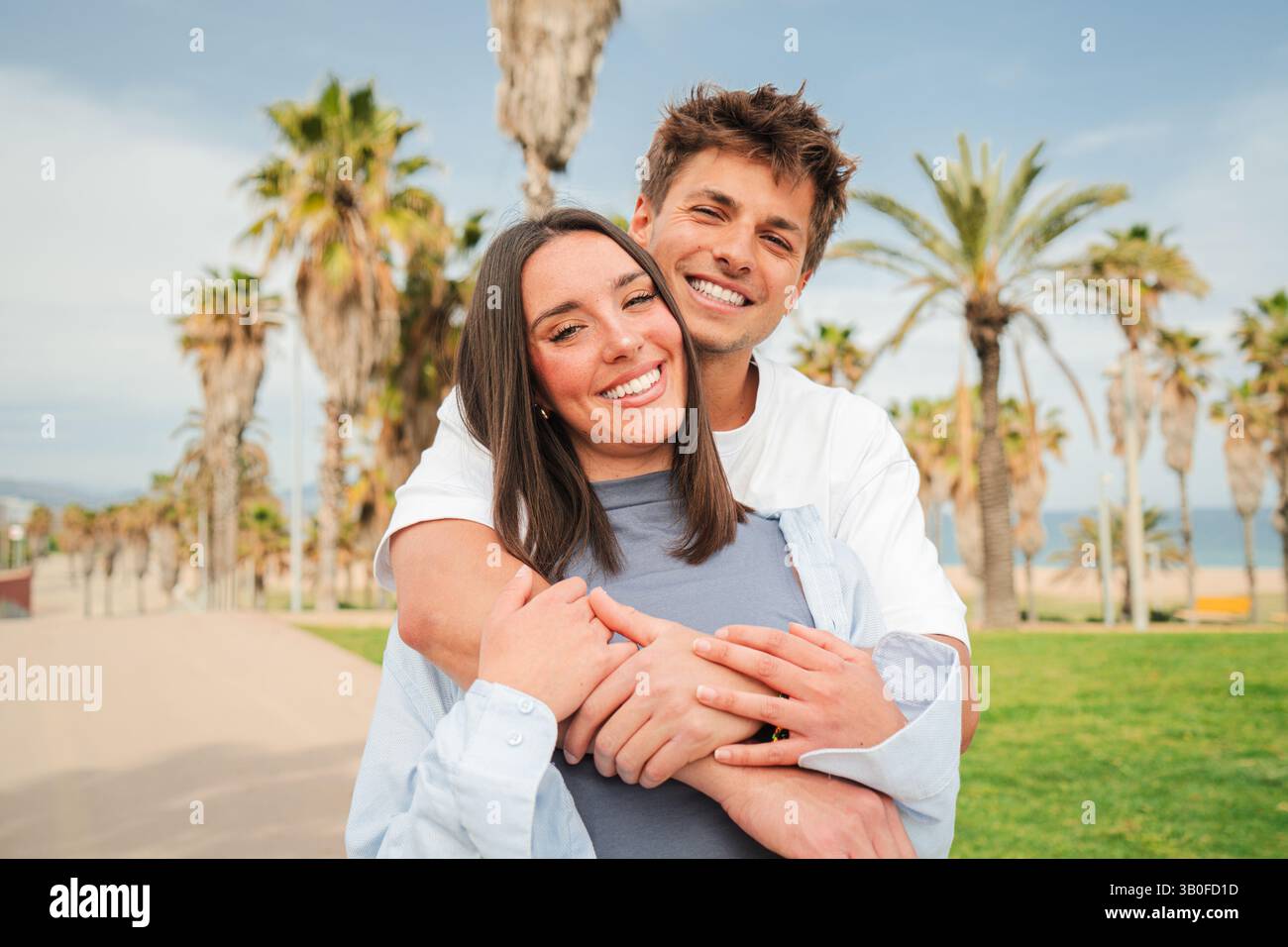 Delighted couple enjoying a tender hug while radiating happiness with ...