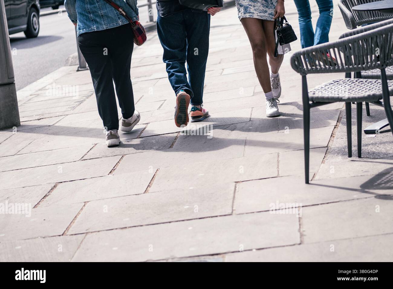 Anonymous pedestrians walking on British high street- lower half view of people with space for text copy Stock Photo