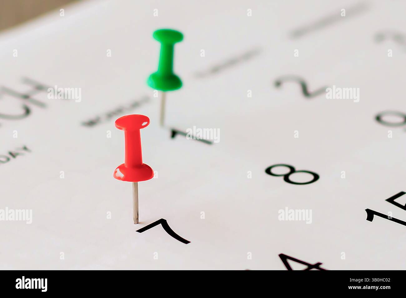 Embroidered pins on a calendar appointment Stock Photo