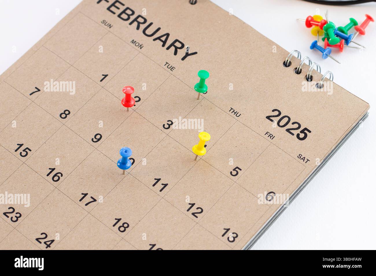 Embroidered pins on a calendar appointment Stock Photo