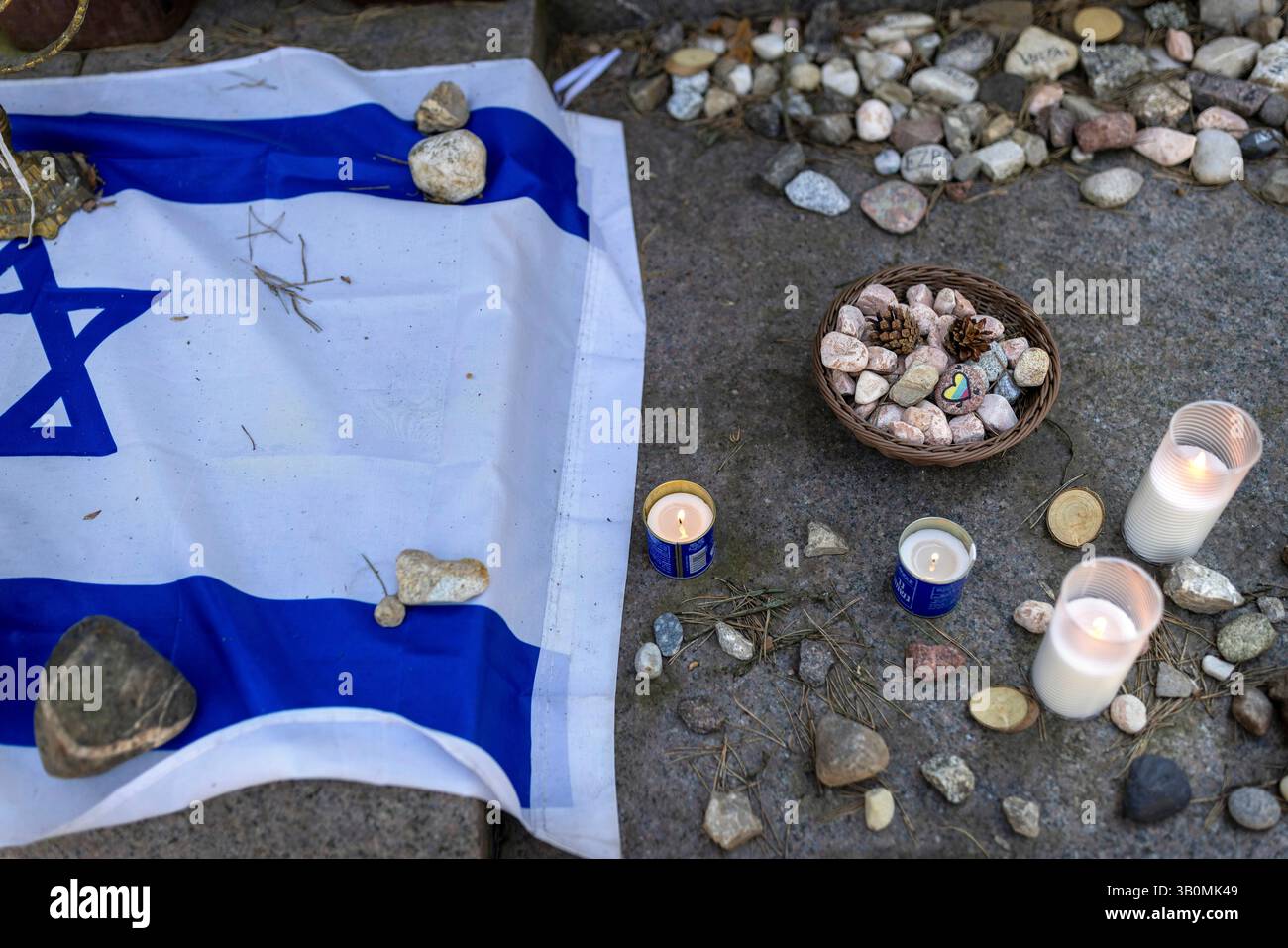 Stones are placed at the foot of a granite Holocaust survivor memorial ...