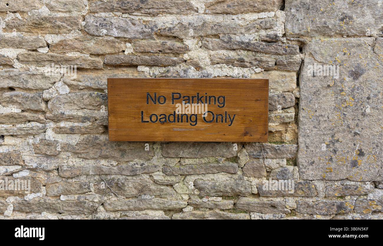 No Parking - Loading Only sign - wood on stone background Stock Photo ...