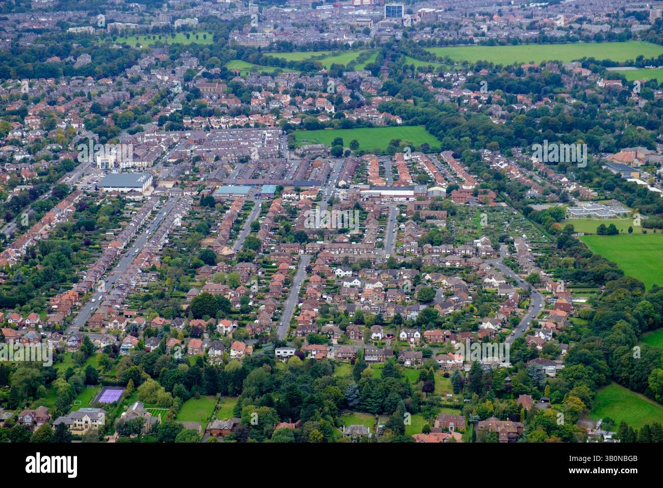 Aerial view of a residential area with houses, roads, and green spaces ...