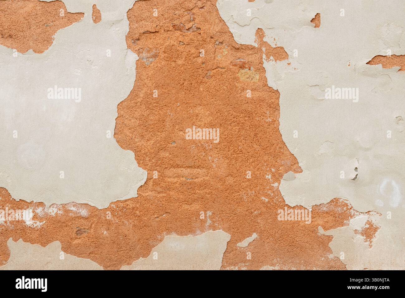 Peeling Wall with Exposed Red Plaster Stock Photo