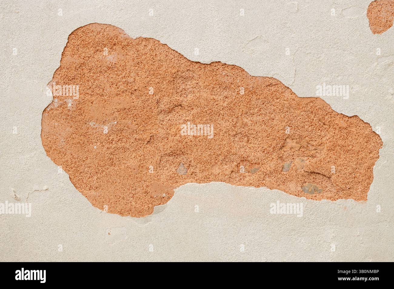Exposed Brick Wall Under Peeling Plaster Stock Photo