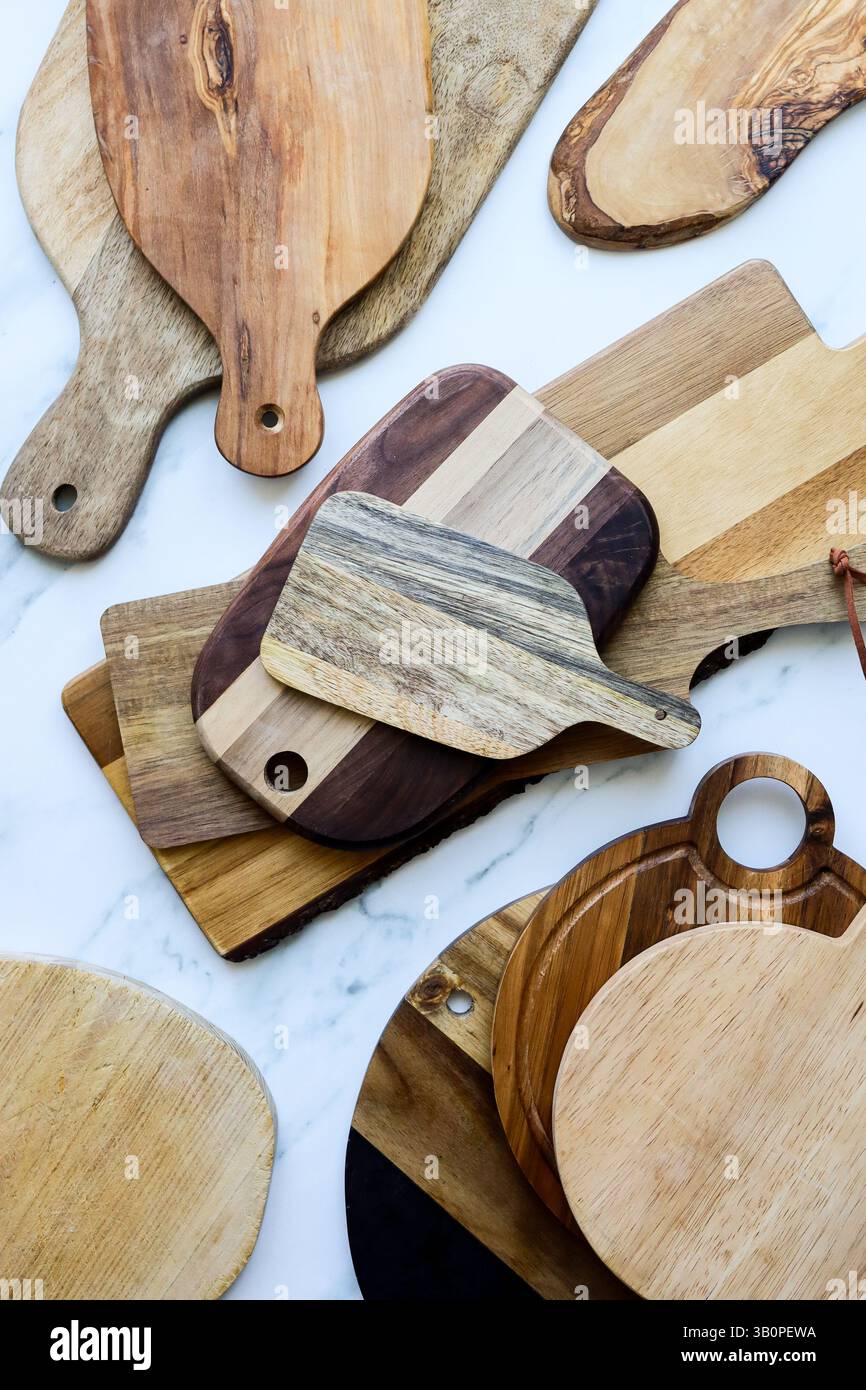 Assorted Wooden Cutting Boards on Marble Kitchen Surface Stock Photo
