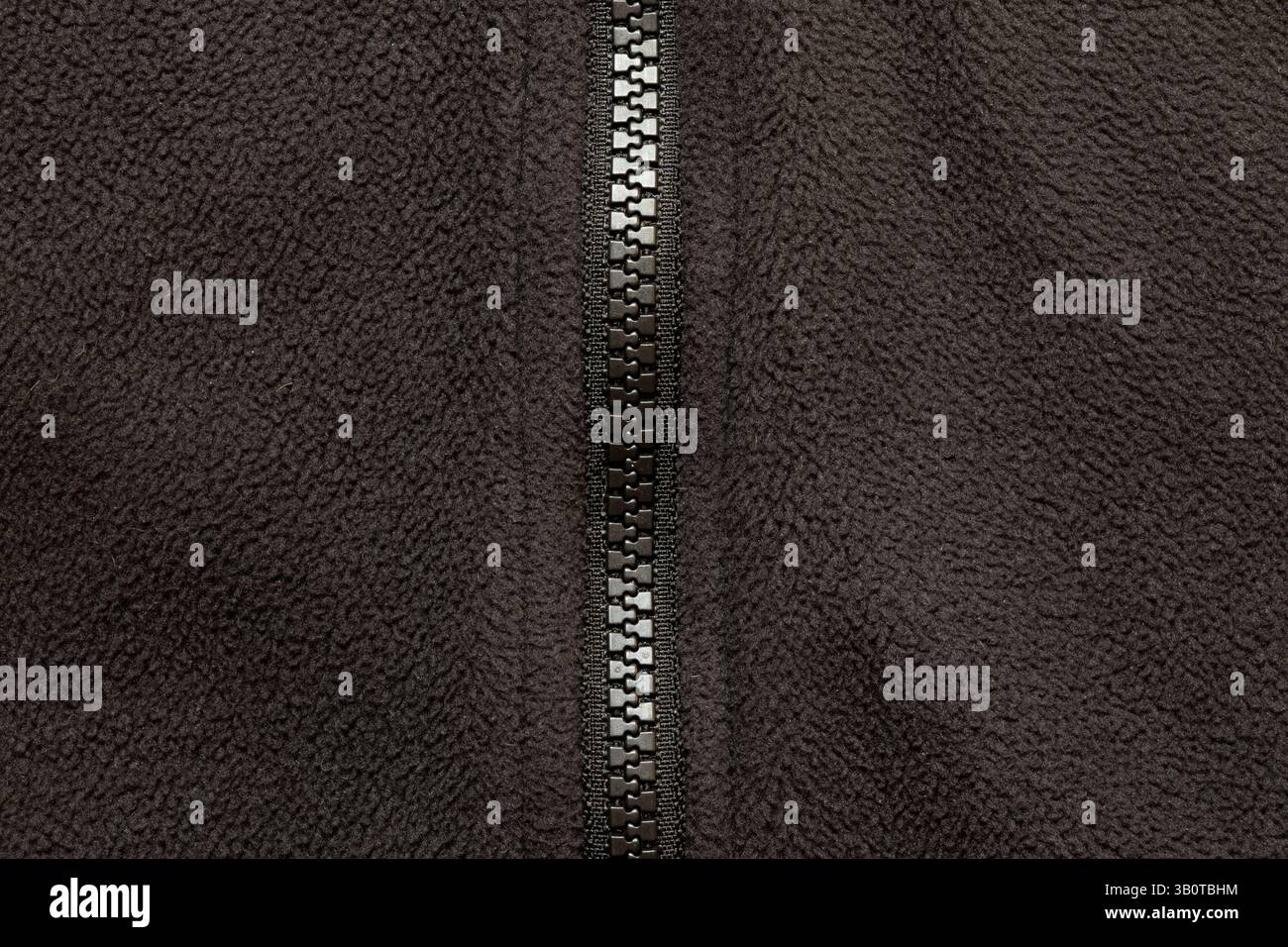Texture of black fleece jacket with zipper close-up, fabric and ...