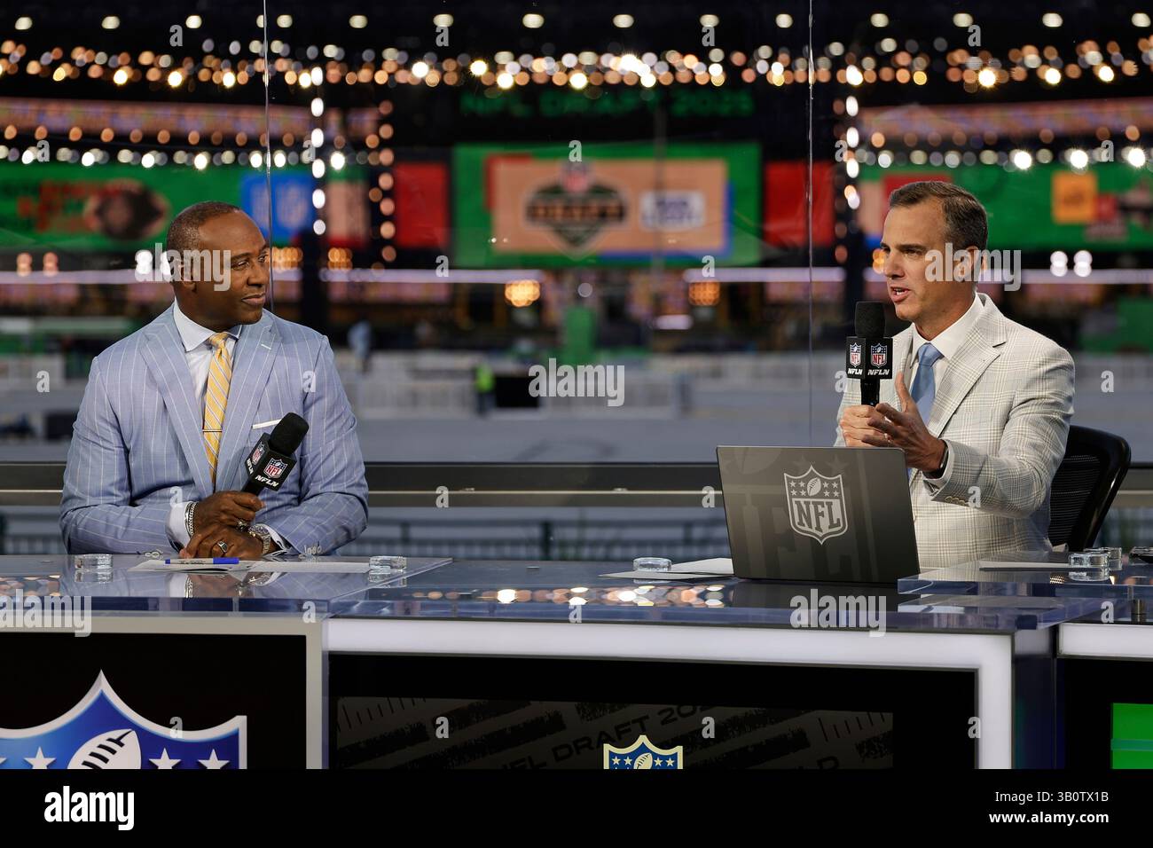 Daniel Jeremiah, right, speaks on set while Charles Davis listens